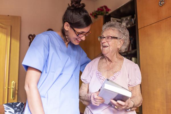 Senior woman smiling with female carer