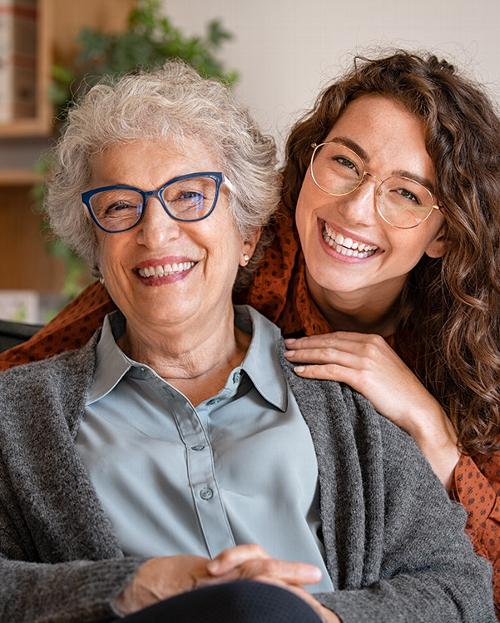 Smiling young and senior woman with glasses