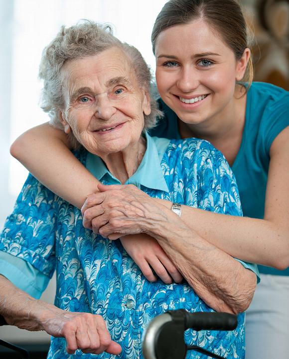 Smiling young woman with elderly woman